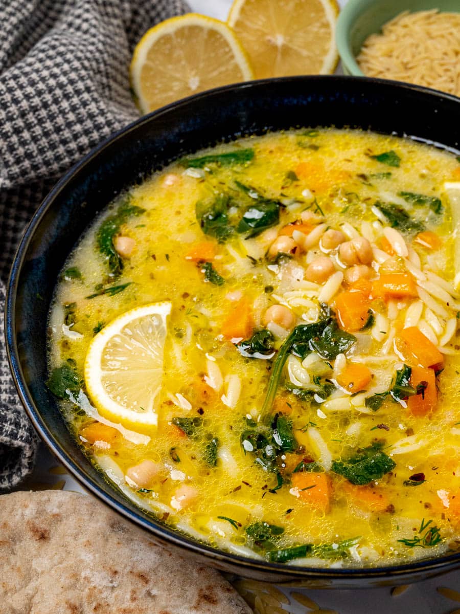 Vegan avgolemono soup with pita on the side.