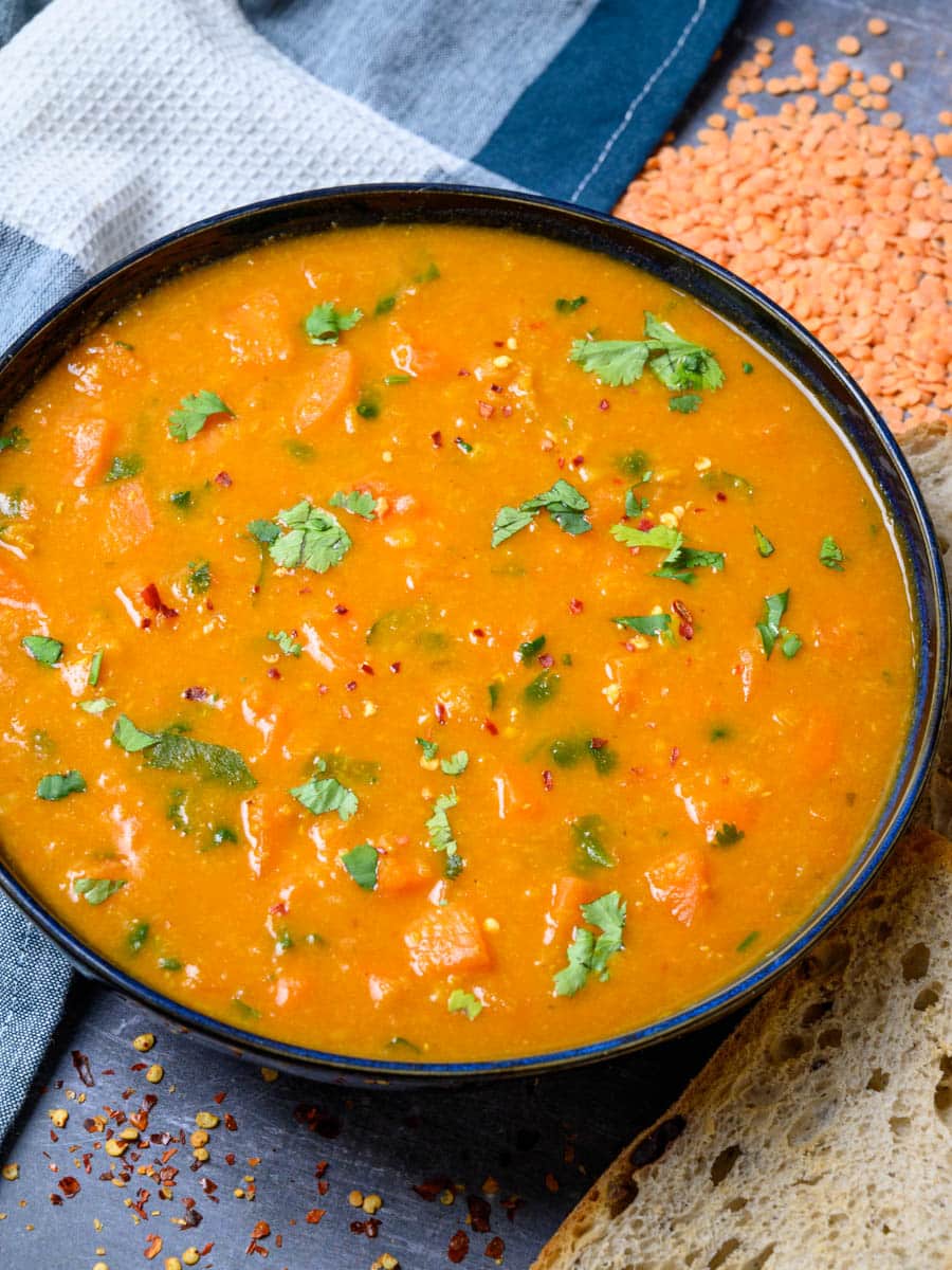 a bowl of a spiced carrot and lentil soup