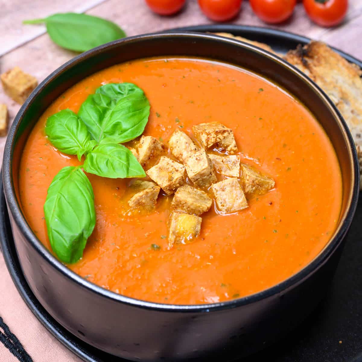 close up photo of a black bowl with soup