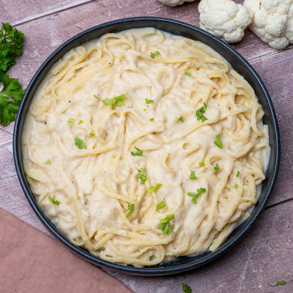 a black plate of pasta