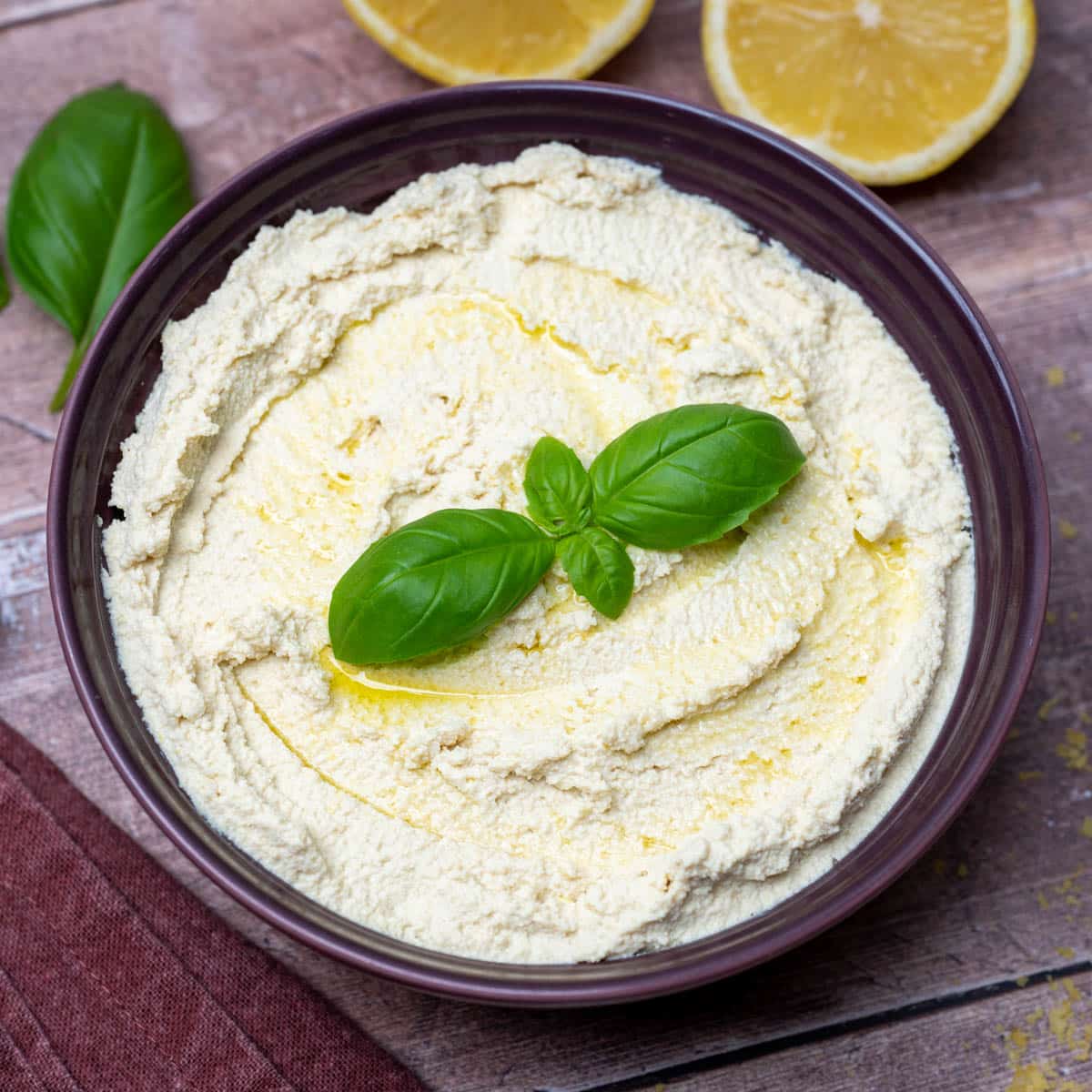 a bowl of blended tofu with basil on top